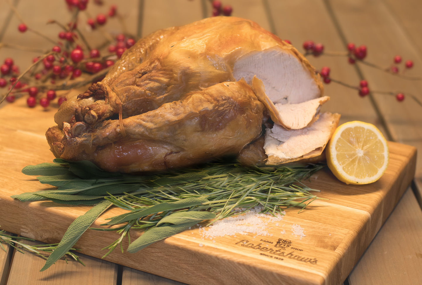 Picture of cooked yorkshire turkey on chopping board with herbs